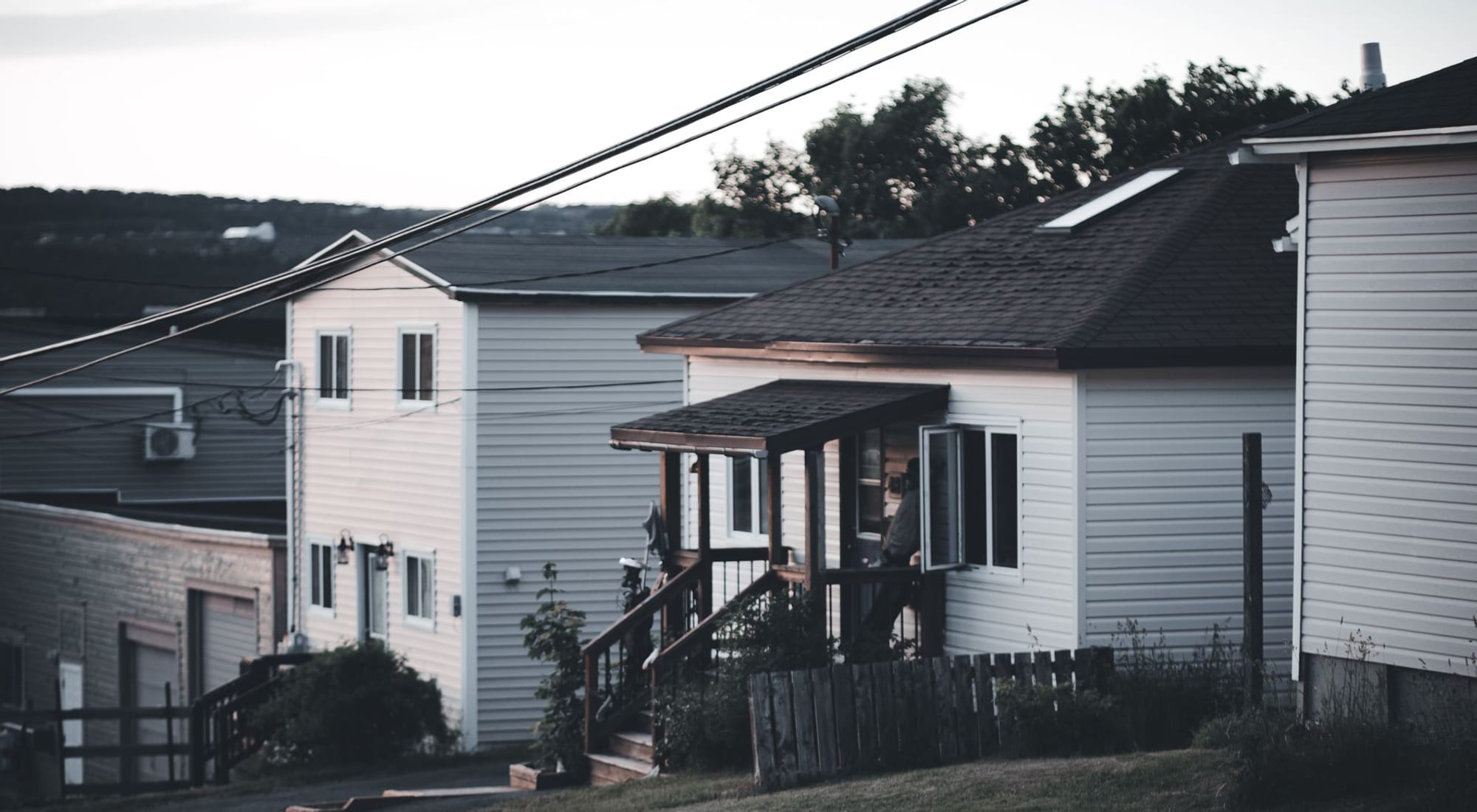A quiet suburban home exterior under a calm, clear evening sky